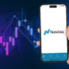 Female hand holding a smartphone iPhone 14 Pro with Nasdaq Stock Exchange app on the screen. Graphic in the background. Rio de Janeiro, RJ, Brazil. March 2023.