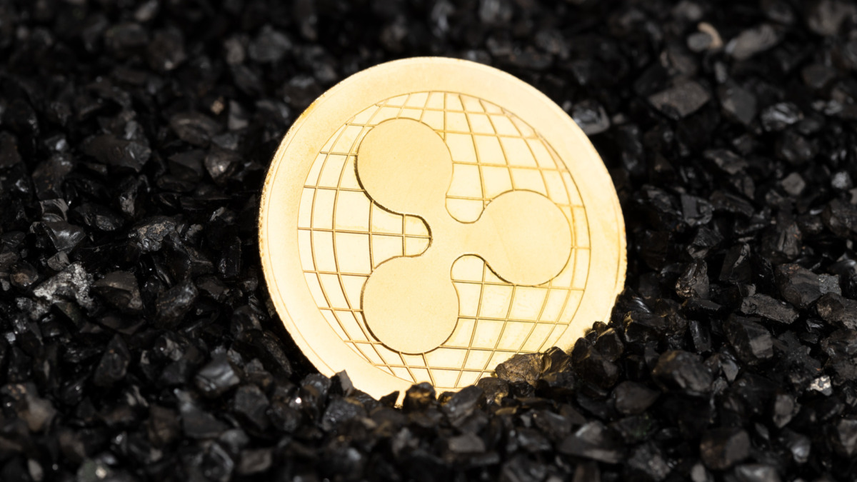 Ripple XRP coin on black gravel background. Cryptocurrency blockchain money