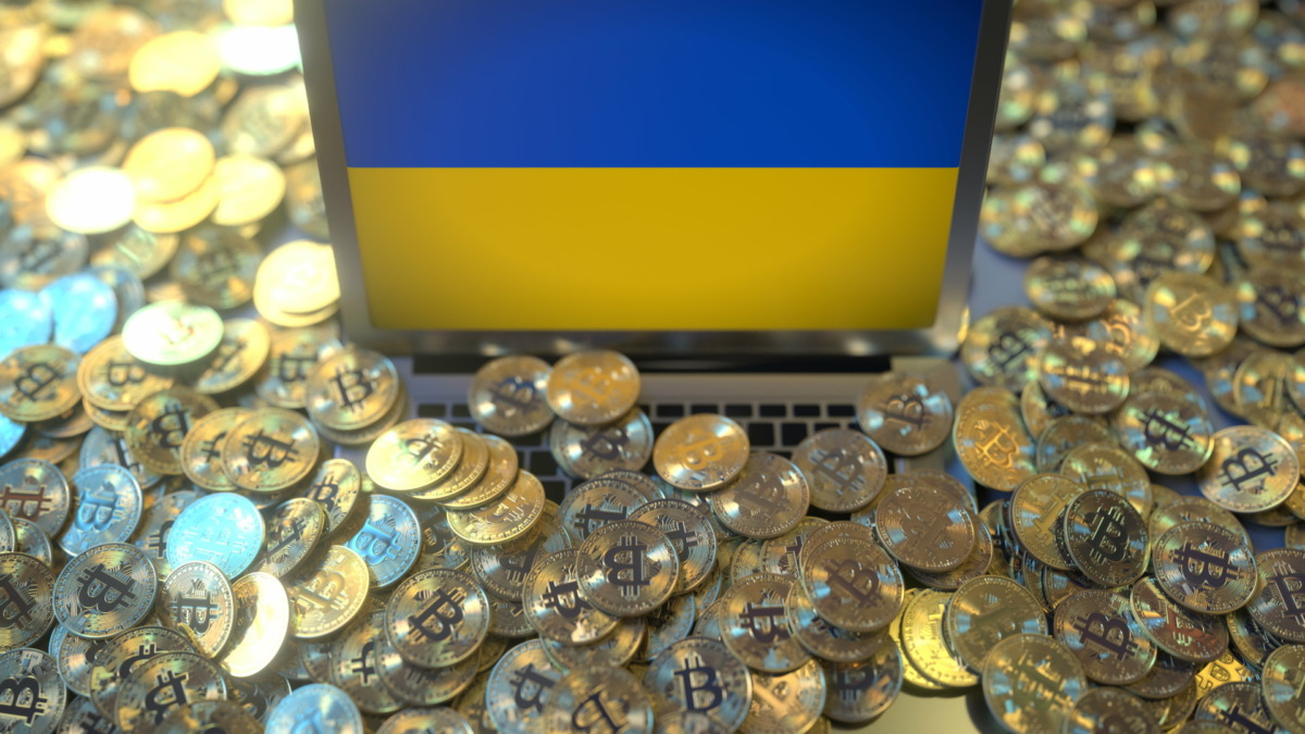 Flag on the laptop screen and many bitcoins. National cryptocurrency regulations and crypto mining concepts
