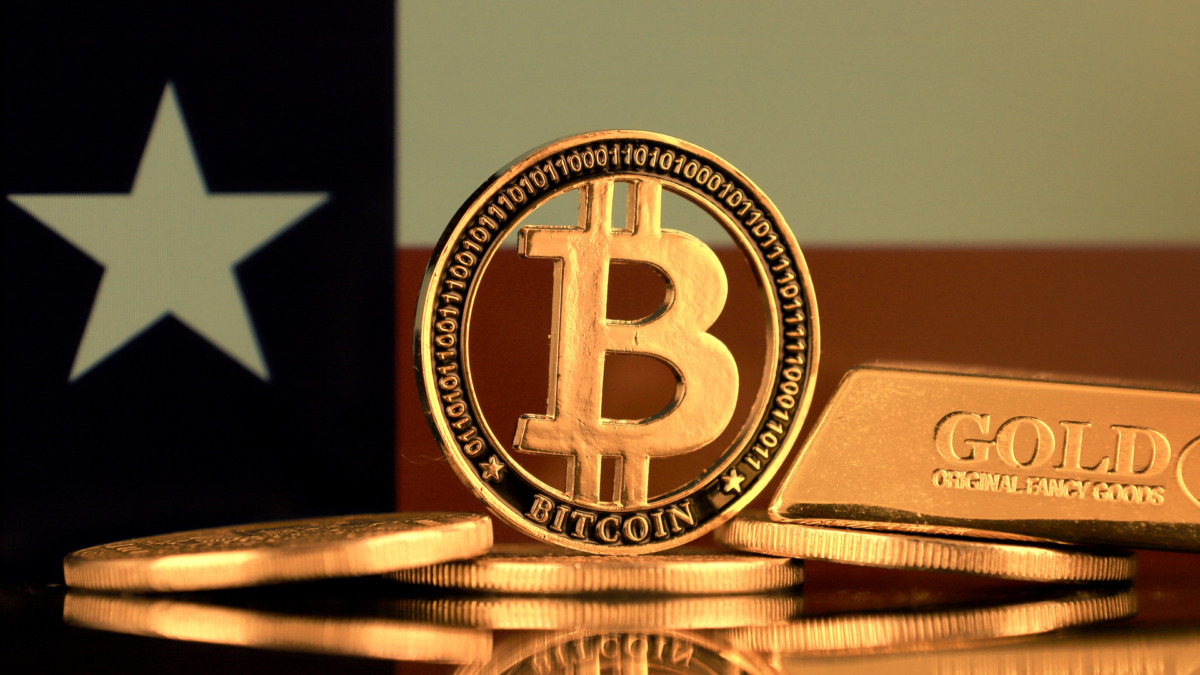 Physical version of Bitcoin, gold bar and Texas State Flag.