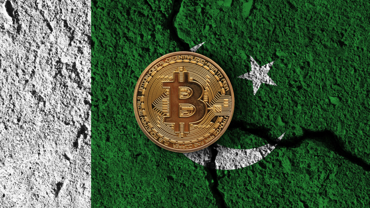 Bitcoin crypto currency coin with cracked Pakistan flag. Crypto restrictions.