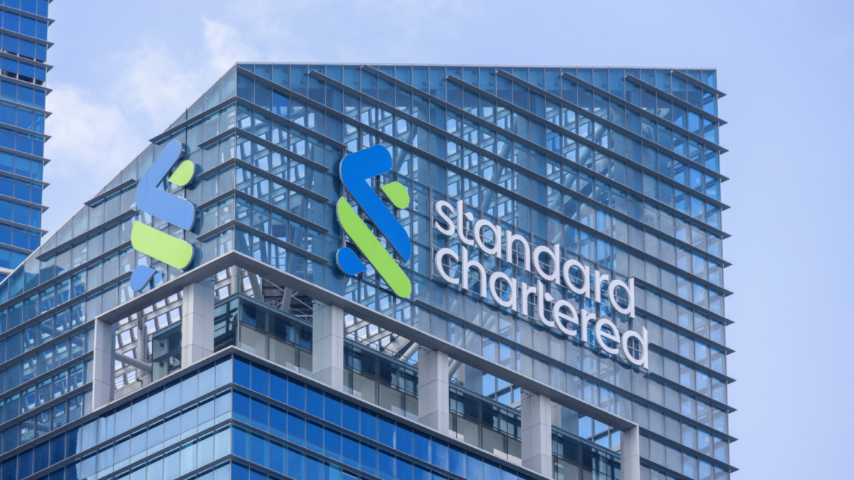 Standard Chartered logo at the roof of the building in Singapore. Standard Chartered PLC is a British banking and financial services company