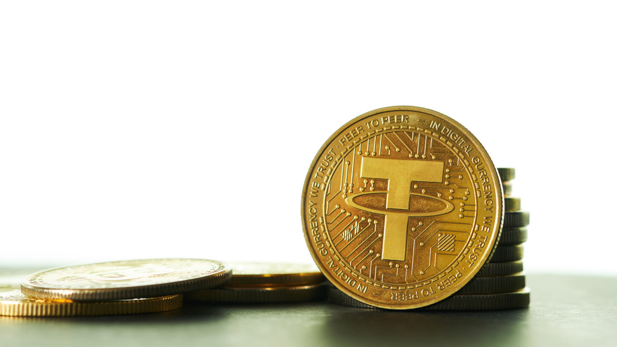 Closeup of Golden Tether cryptocurrency with white background and copy space