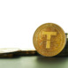 Closeup of Golden Tether cryptocurrency with white background and copy space