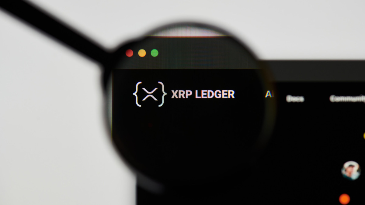 Milan, Italy - January 11, 2022: xrp - XRP website's hp. xrp, XRP coin logo visible through a loope. Defi, ntf, cryptocurrency concepts illustrative editorial.