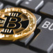 bitcoin and computer keyboard with buttons buy & sell
