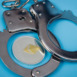 One ethereum coin and handcuffs over blue background.