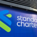 Close-up details of the Standard Chartered Bank logo and signage on the building exterior, showcasing the bank's modern branding.