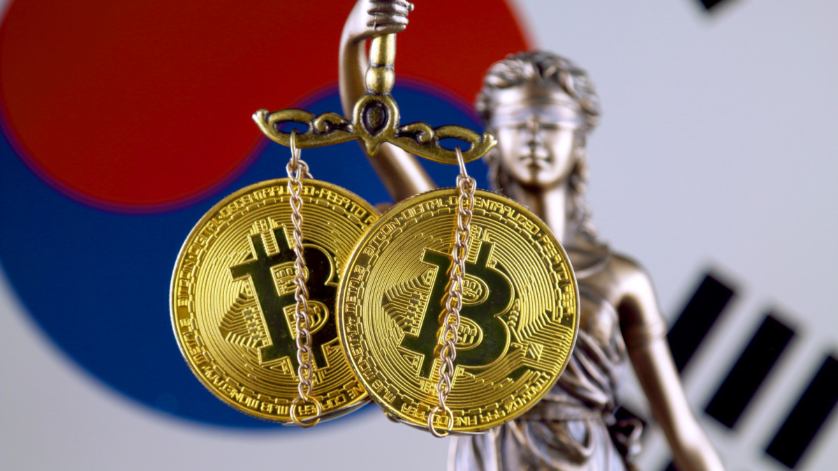 Symbol of law and justice, physical version of Bitcoin and South Korea Flag. Prohibition of cryptocurrencies, regulations, restrictions or security, protection, privacy.