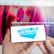 Logo of company Animoca Brands. Production of applications, crypto games. Buy land in virtual world. Blockchain nft cryptocurrency strategy.Man with mobile phone.Play-to-earn.