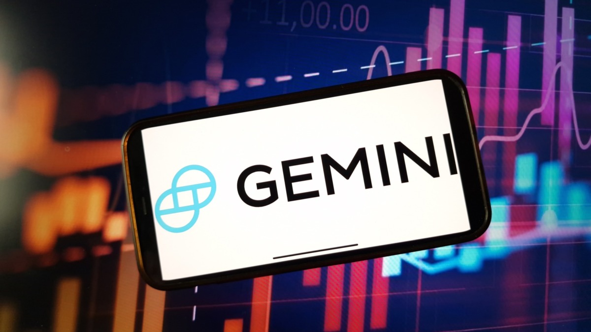 Gemini cryptocurrency exchange logo displayed on smartphone on crypto market data background