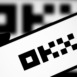 Okx logo is displayed on smartphone. Okx is a cryptocurrency platform.