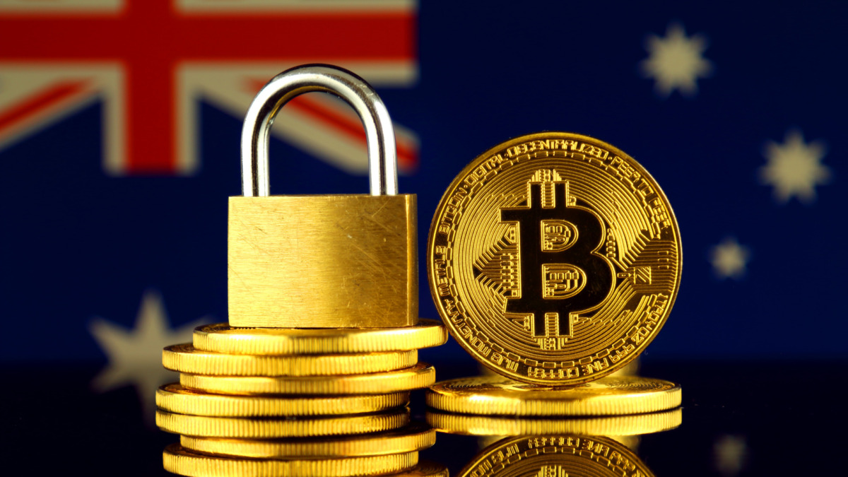 Physical version of Bitcoin, golden padlock and Australia Flag. Prohibition of cryptocurrencies, regulations, restrictions or security, protection, privacy.
