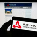 Stuttgart, Germany - 09-19-2022: Person holding smartphone with logo of financial institution People's Bank of China on screen in front of website. Focus on phone display.