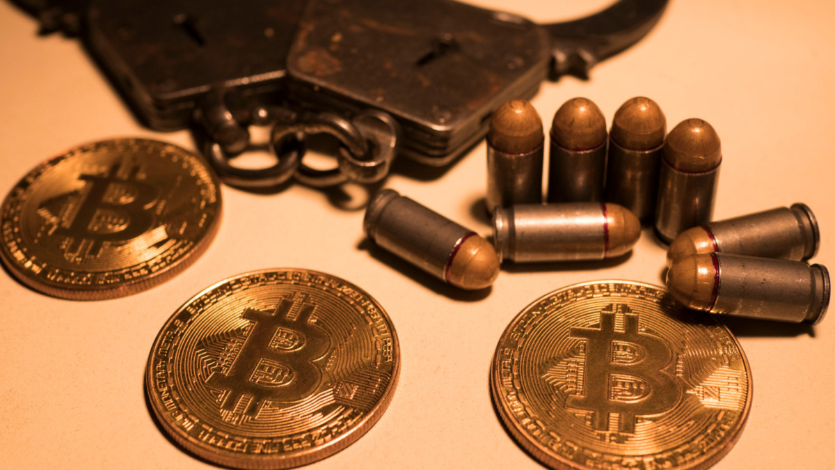 bitcoins and bullets on wooden table