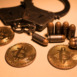 bitcoins and bullets on wooden table