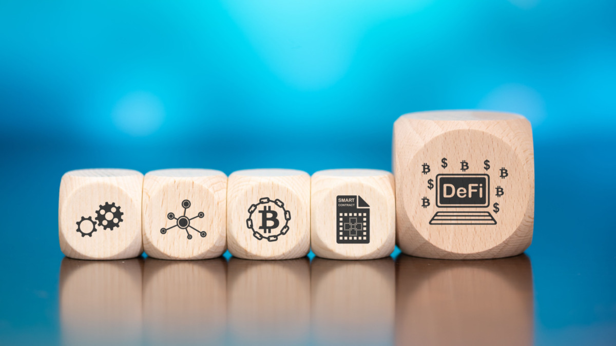 Wooden blocks with symbol of defi concept on blue background