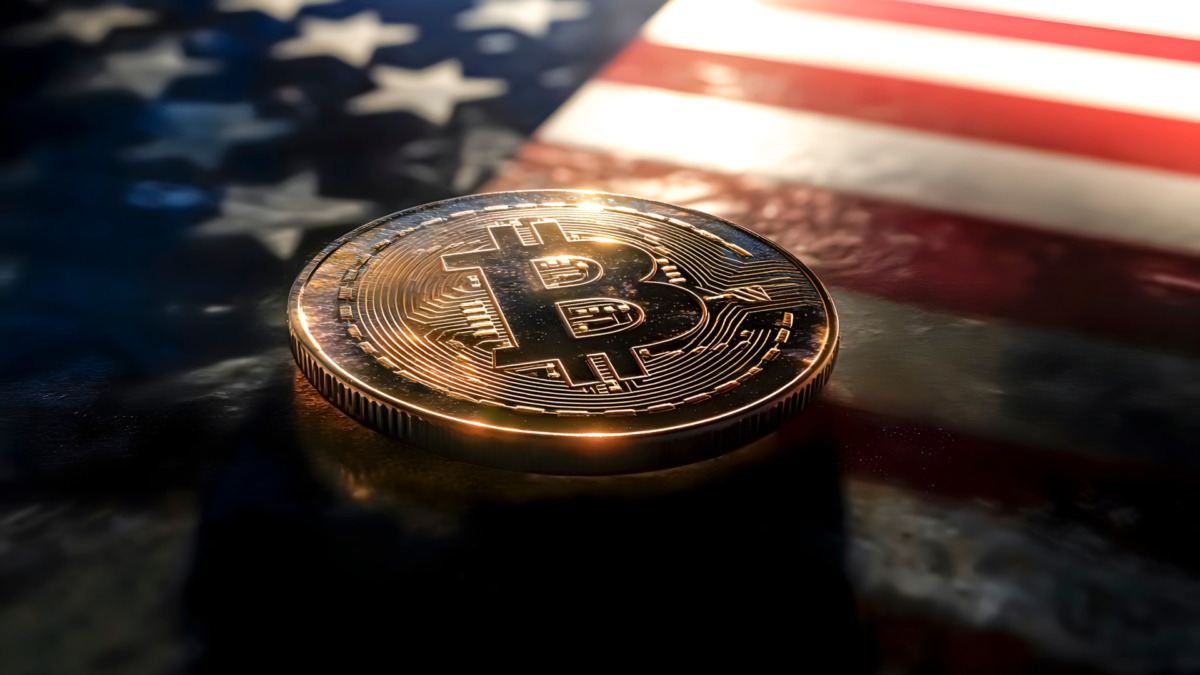 A bitcoin coin with the U.S. flag in the background. Cryptocurrencies. Federal Reserve.