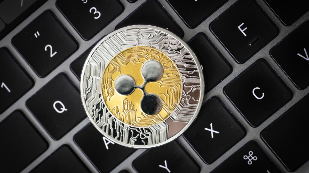 Ripple cryptocurrency, physical coin laying on a laptop keyboard