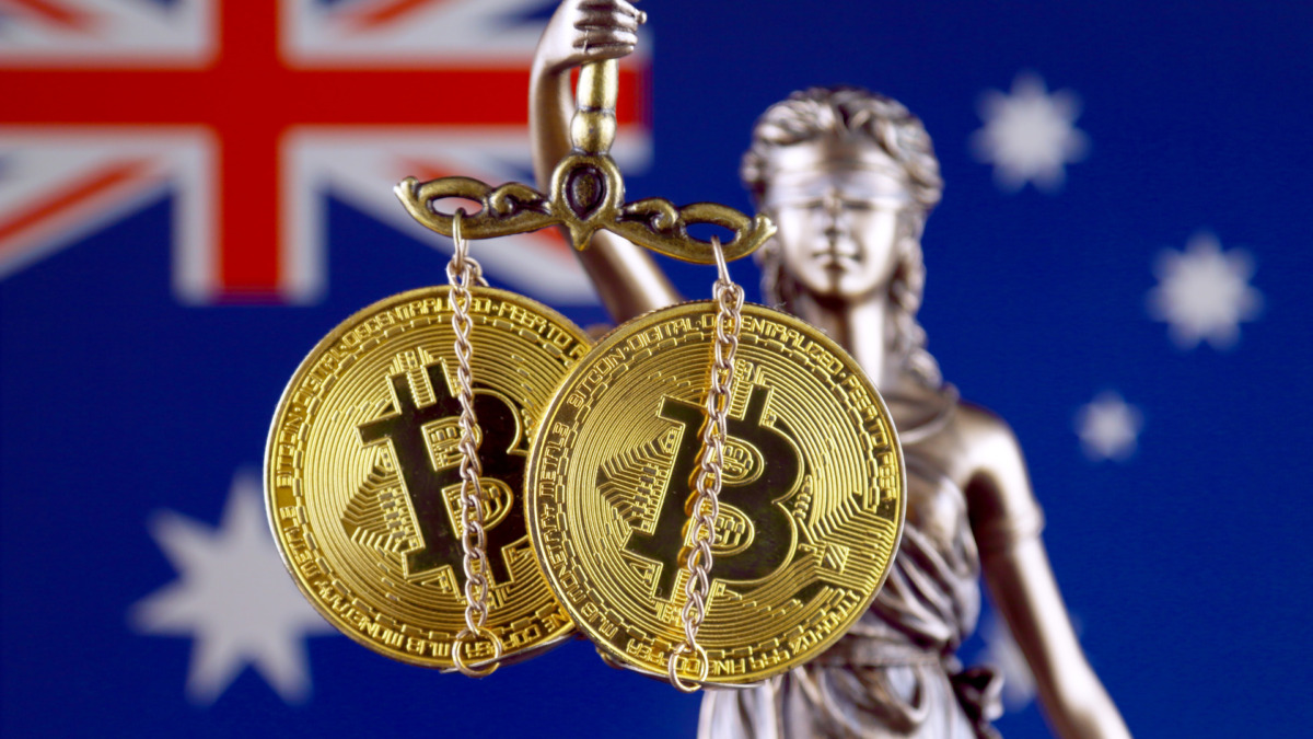 Symbol of law and justice, physical version of Bitcoin and Australia Flag. Prohibition of cryptocurrencies, regulations, restrictions or security, protection, privacy.