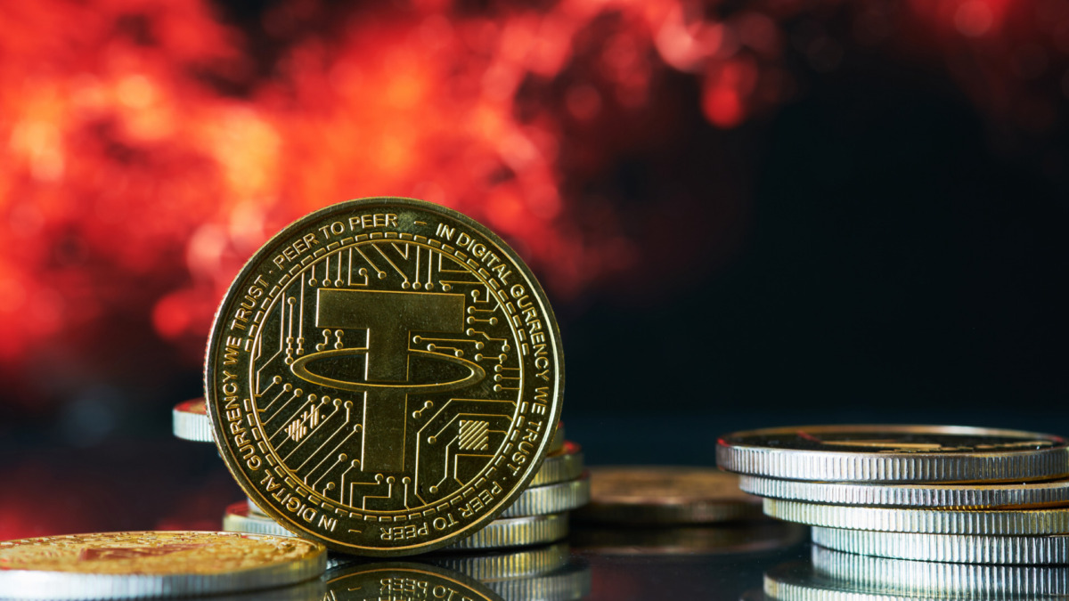 Various golden cryptocurrencies highlighting Tether coin with red and black abstract background