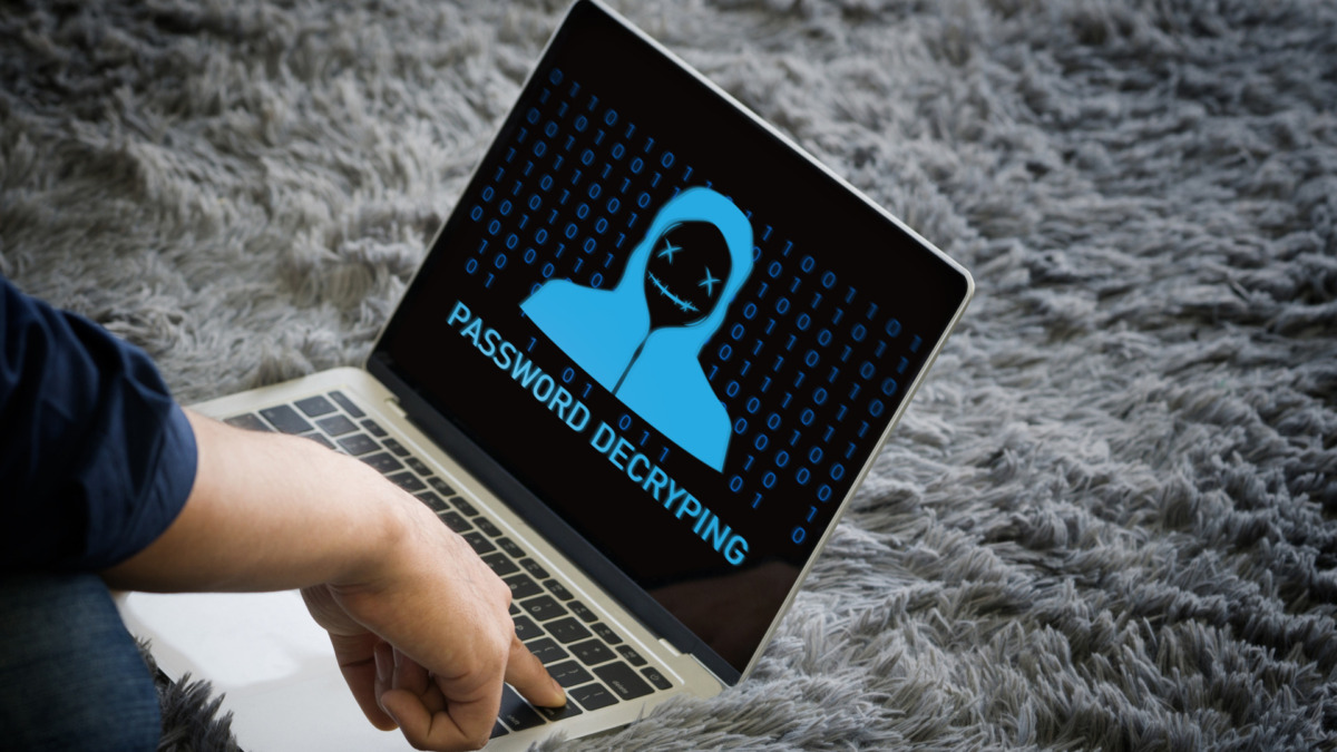 Young man use his finger press enter key on laptop computer keyboard, password decrypting displayed on the screen.
