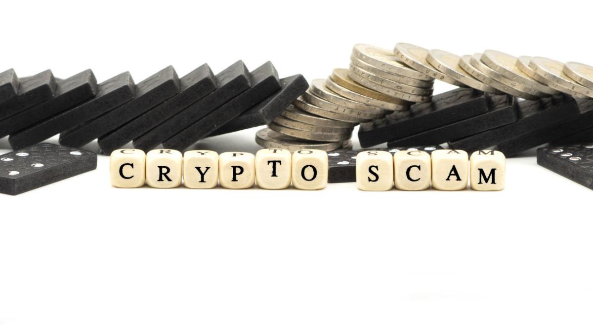 Crypto or cryptocurrency scam concept with coins and letter cubes on white background