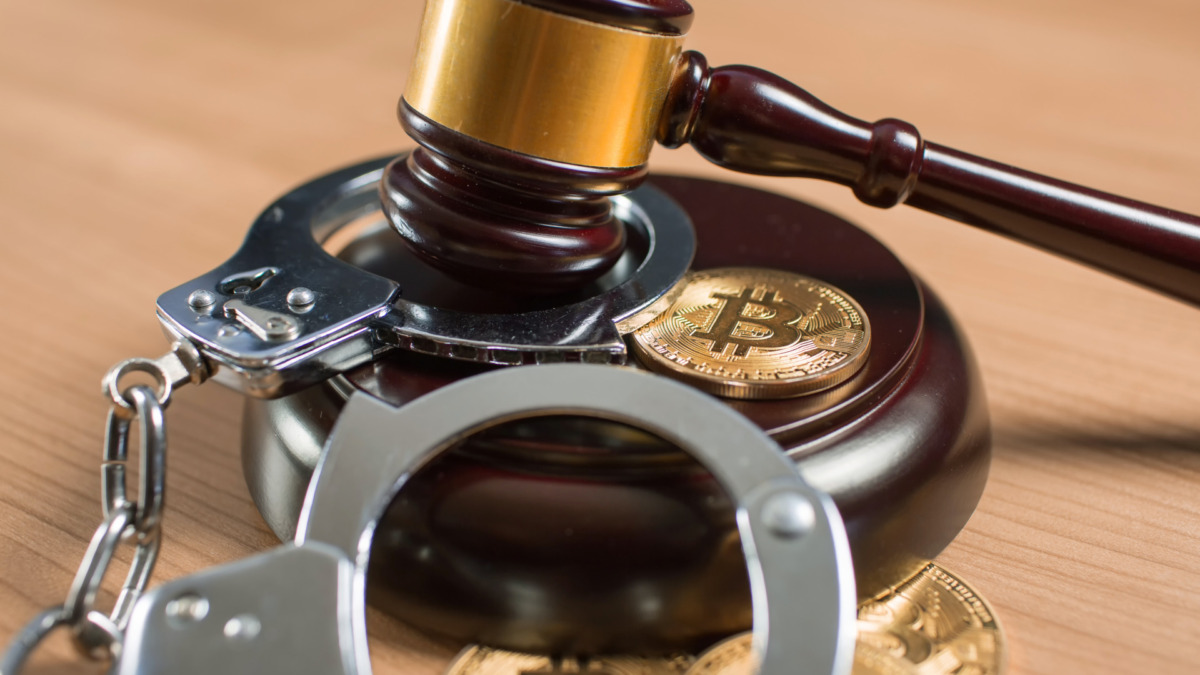 Bitcoin regulation. BTC cryptocurrency coin and judge gavel on a desk. Banned currency or law enforcement concept.