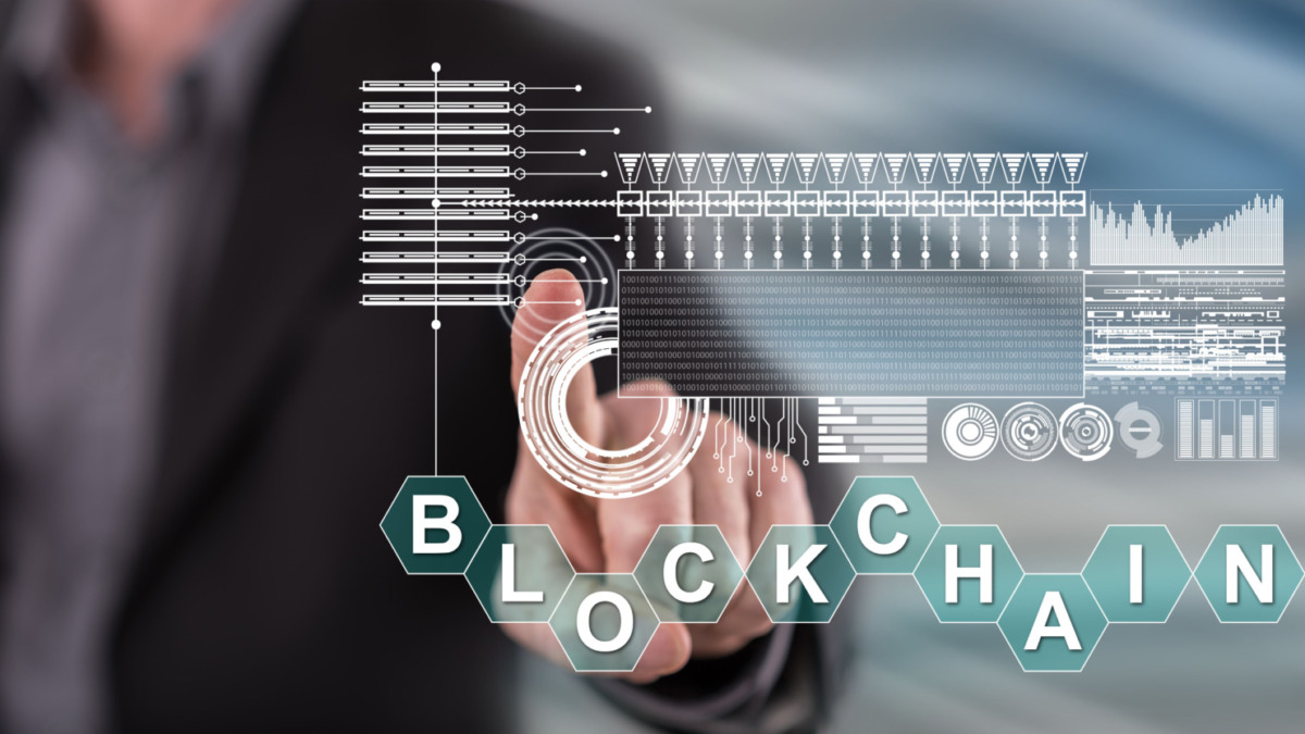 Man touching a blockchain concept on a touch screen with his finger