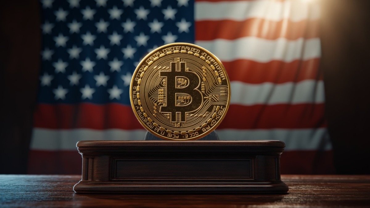 A golden Bitcoin stands on a pedestal, illuminated against a backdrop of the American flag, symbolizing cryptocurrency's intersection with national identity.