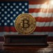 A golden Bitcoin stands on a pedestal, illuminated against a backdrop of the American flag, symbolizing cryptocurrency's intersection with national identity.