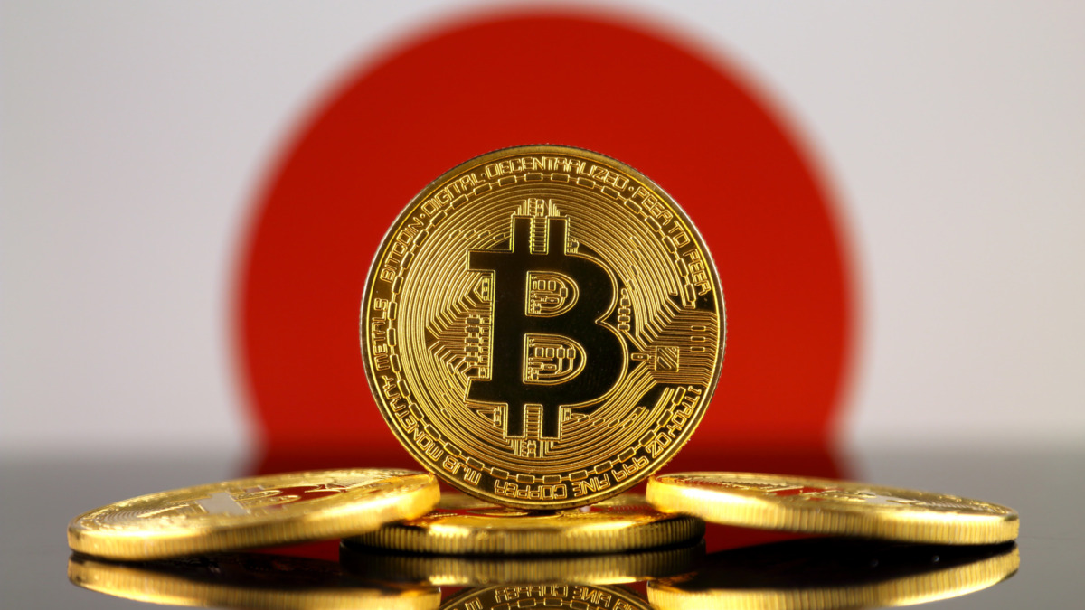 Physical version of Bitcoin (new virtual money) and Japan Flag. Conceptual image for investors in cryptocurrency and Blockchain Technology in Japan.