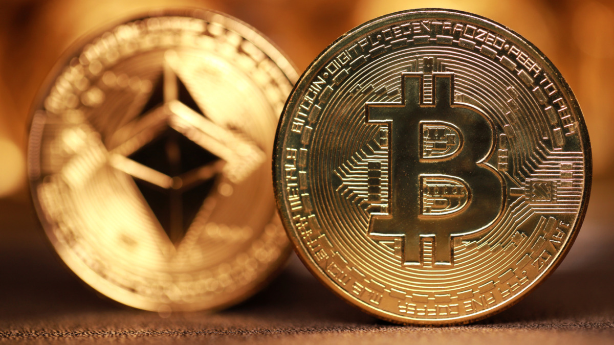 Bitcoin and ethereum coin on a defocused background. Trading on the cryptocurrency exchange.