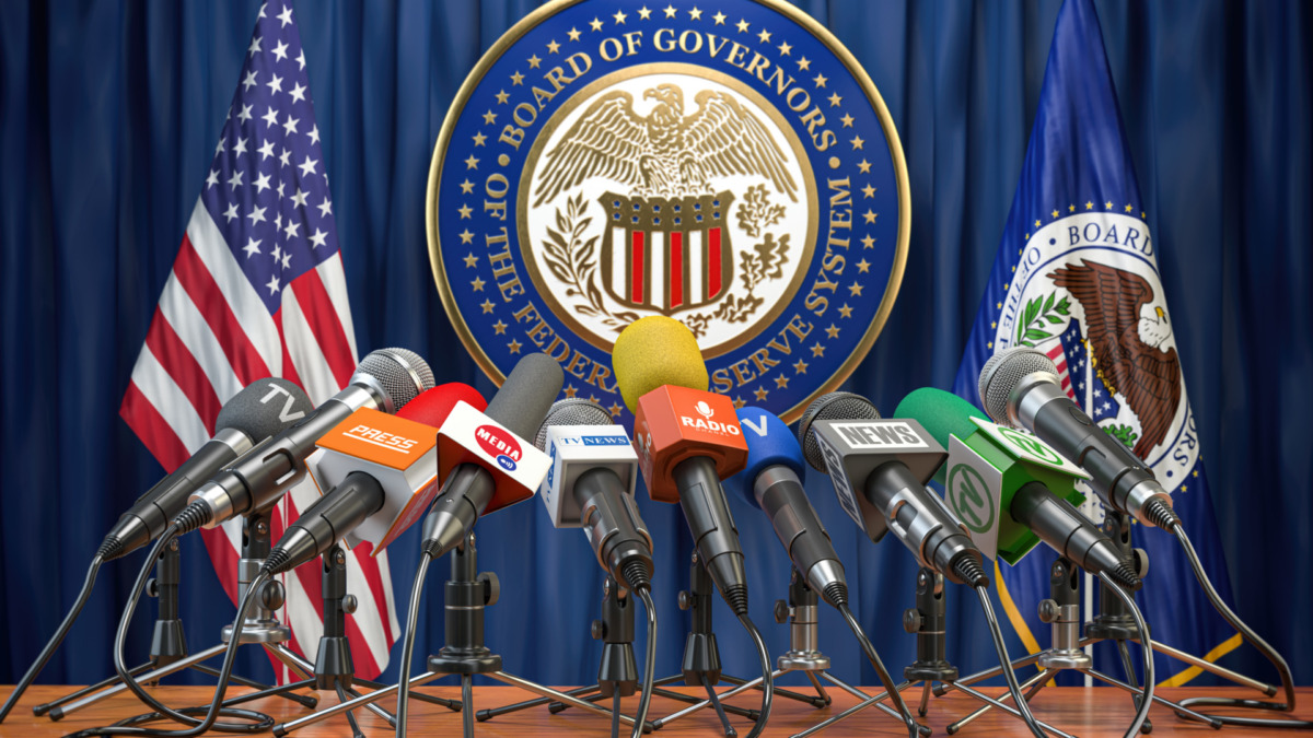 Federal Reserve System Fed of USA press conference concept. Microphones TV and radio channels with symbol and flag of US Federal Reserve. 3d illustration