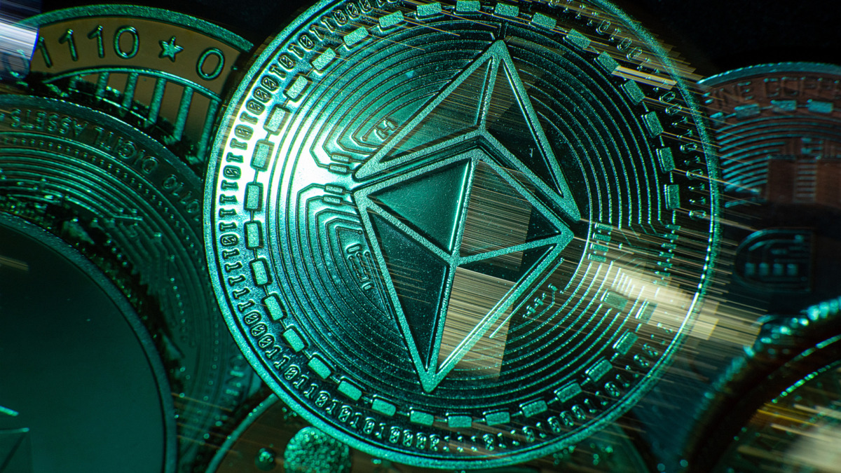 Horizontal view of cryptocurrency tokens including Ethereum seen from above on a black background with light trails. High quality photo