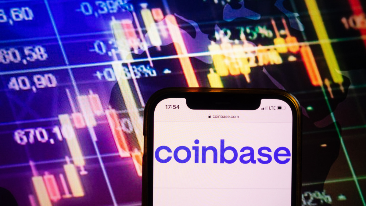 KONSKIE, POLAND - August 10, 2022: Smartphone displaying logo of Coinbase cryptocurrency exchange on stock exchange diagram background