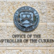 Office of the Comptroller of Currency sign and logo in downtown