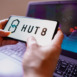 In this photo illustration, the Hut 8 Mining logo seen displayed on a smartphone screen