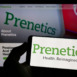Person holding mobile phone with logo of biotechnology company Prenetics Limited on screen in front of business web page. Focus on phone display.