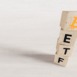 Exchange Traded Fund (ETF) and Bitcoin cryptodivisa concept. Introduce the concept of digital money background. Wooden vertical cube with bitcoin icon standing with "ETF" text. White background, 3D