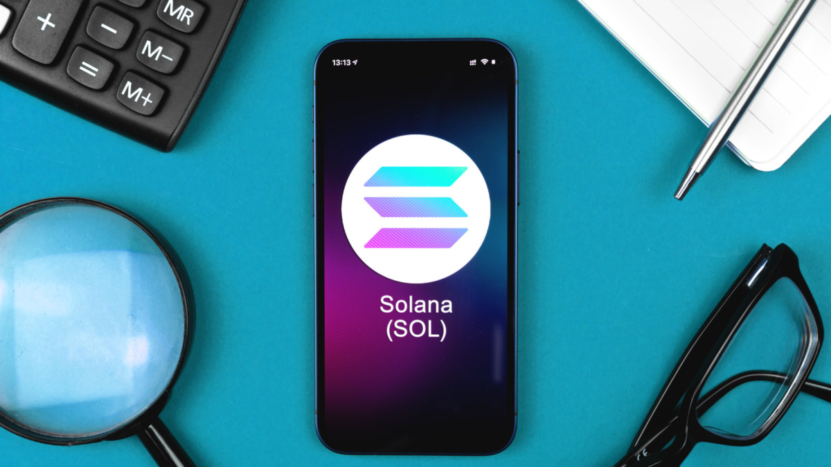 Solana SOL symbol. Trade with cryptocurrency, digital and virtual money, banking with mobile phone concept. Business workspace, table top view