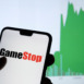 Gamestop retail company logo on the smartphone and its authentic stock price chart for the last 5 days. Stafford, United Kingdom - January 27 2021.
