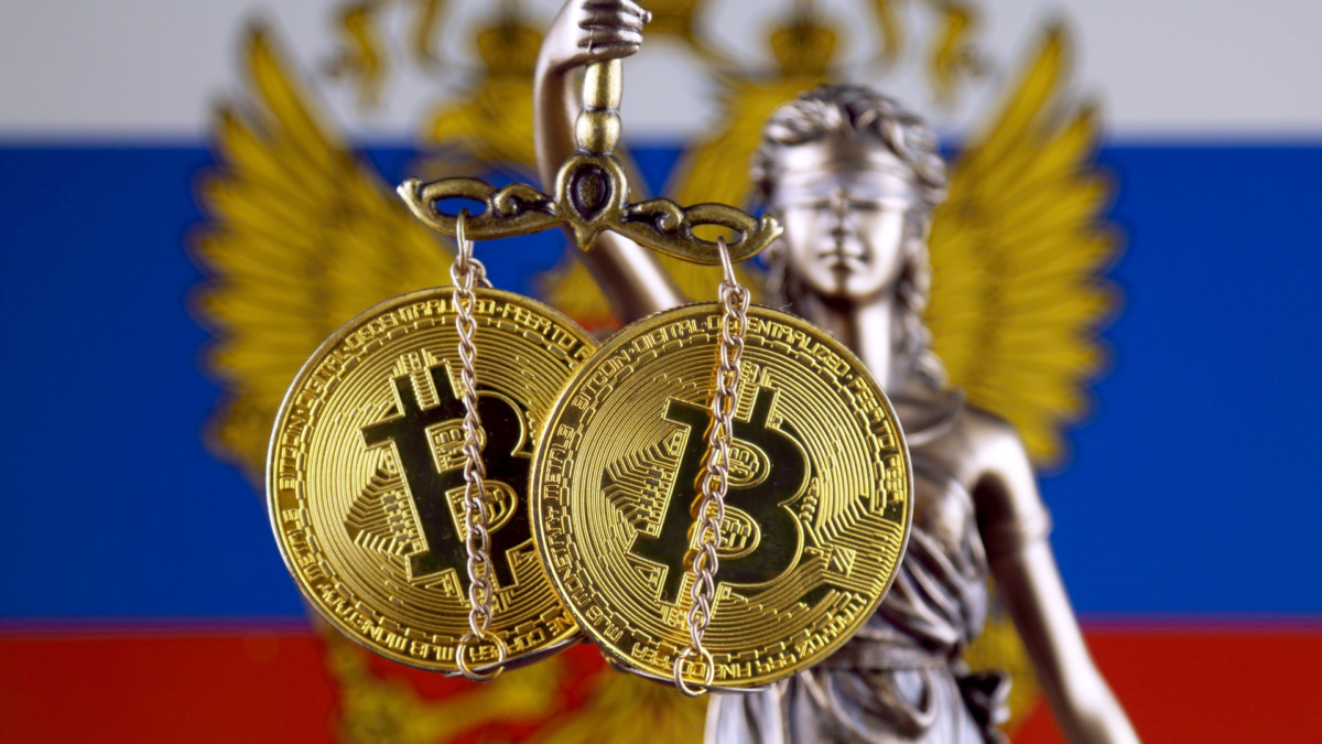 Symbol of law and justice, physical version of Bitcoin and Russia Flag. Prohibition of cryptocurrencies, regulations, restrictions or security, protection, privacy.