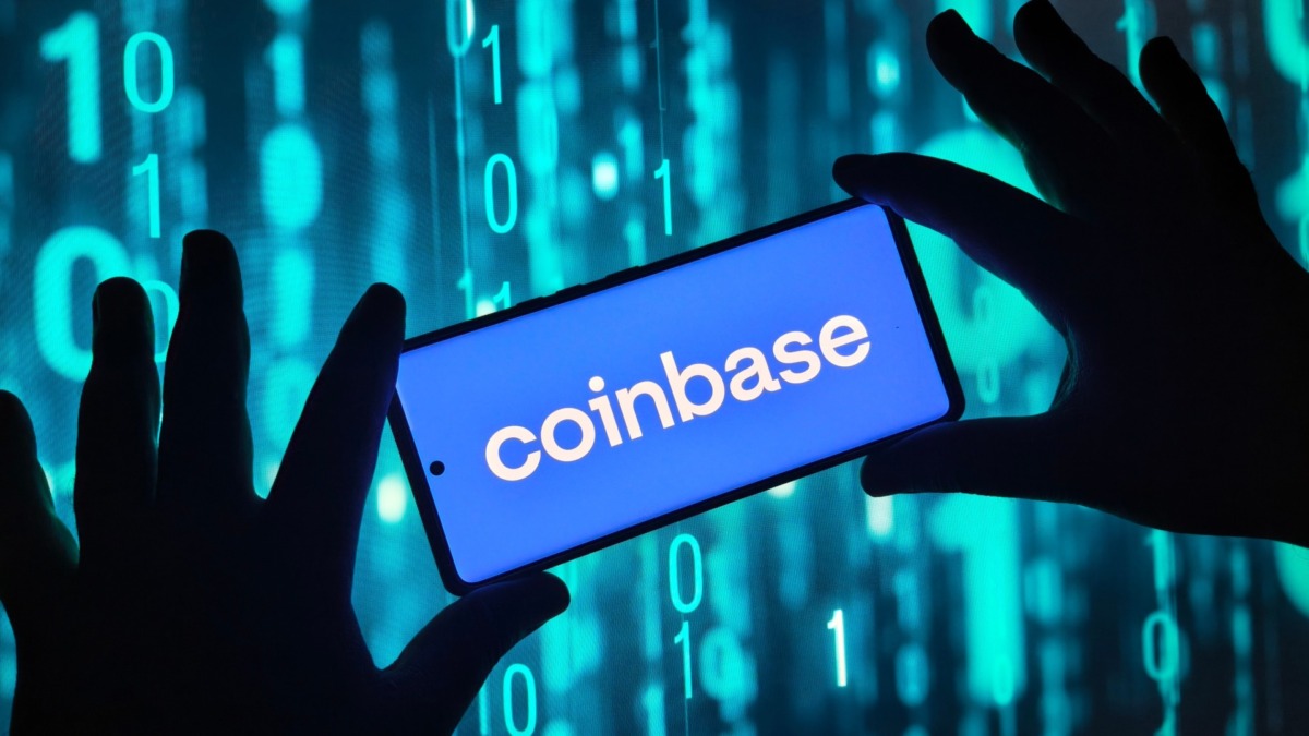 Hands holding smartphone with Coinbase app on screen