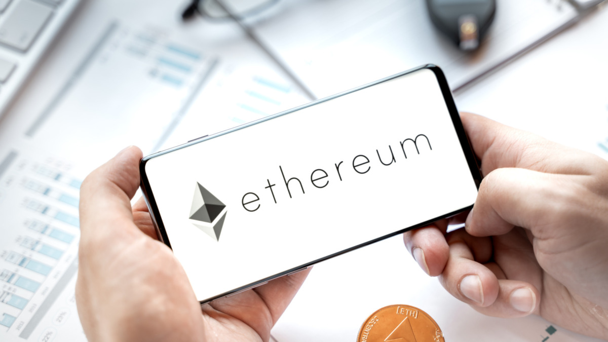 Russia Moscow 24.06.21 Logo of Ethereum coin in mobile phone. Cryptocurrency ETH token. Trading blockchain platform to buy,sell on decentralized exchange DEX. Digital money.Business,investing.