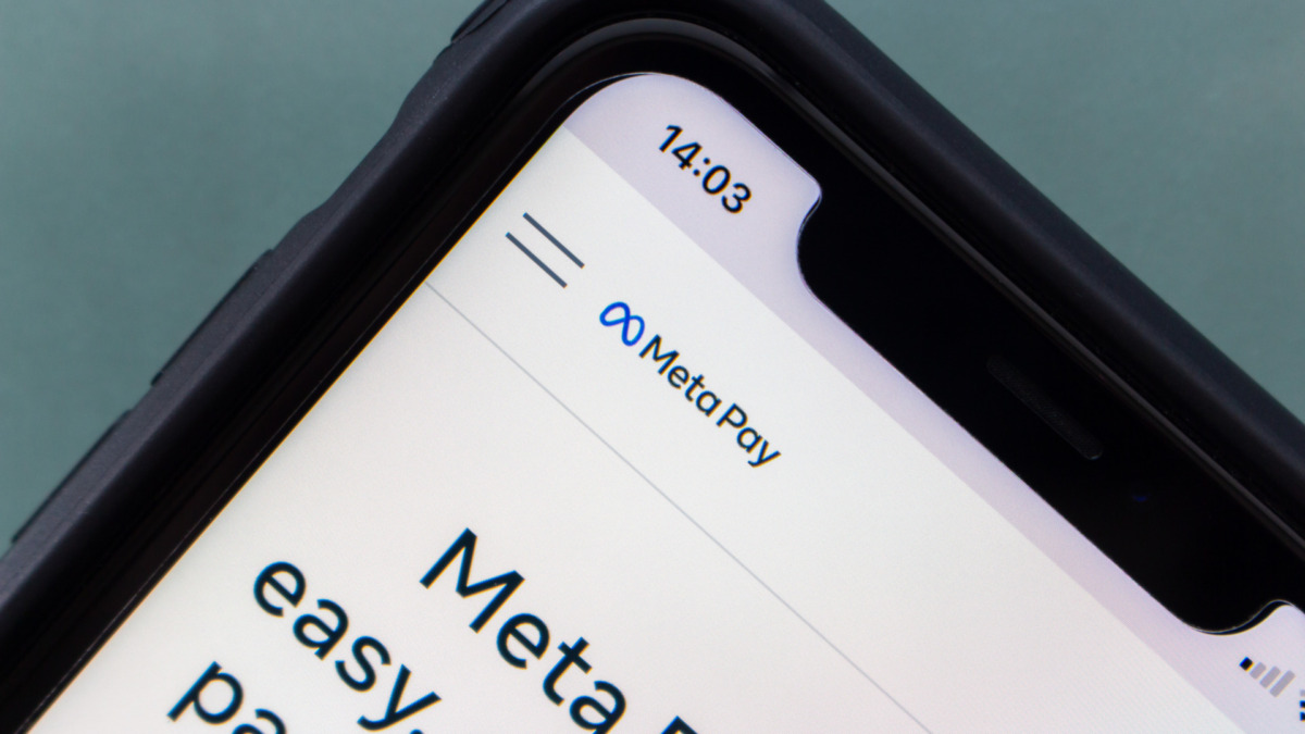 Closeup logo of Meta Pay, a payments service on Facebook, Messenger, Instagram, and in participating online stores, seen in its website on an iPhone.