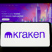 Stuttgart, Germany - 09-26-2022: Person holding mobile phone with logo of American crypto company Payward Inc. (Kraken) on screen in front of web page. Focus on phone display.