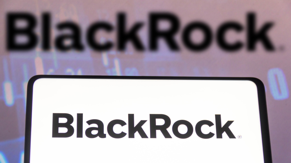 In this photo illustration a BlackRock logo seen displayed on a smartphone screen and in the background