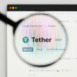 tether - USDT website's hp. tether, USDT coin logo visible through a loope. Defi, ntf, cryptocurrency concepts illustrative editorial.